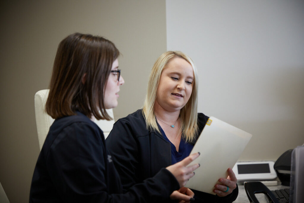 Staff at South Bend Oral Surgery looking over dental files