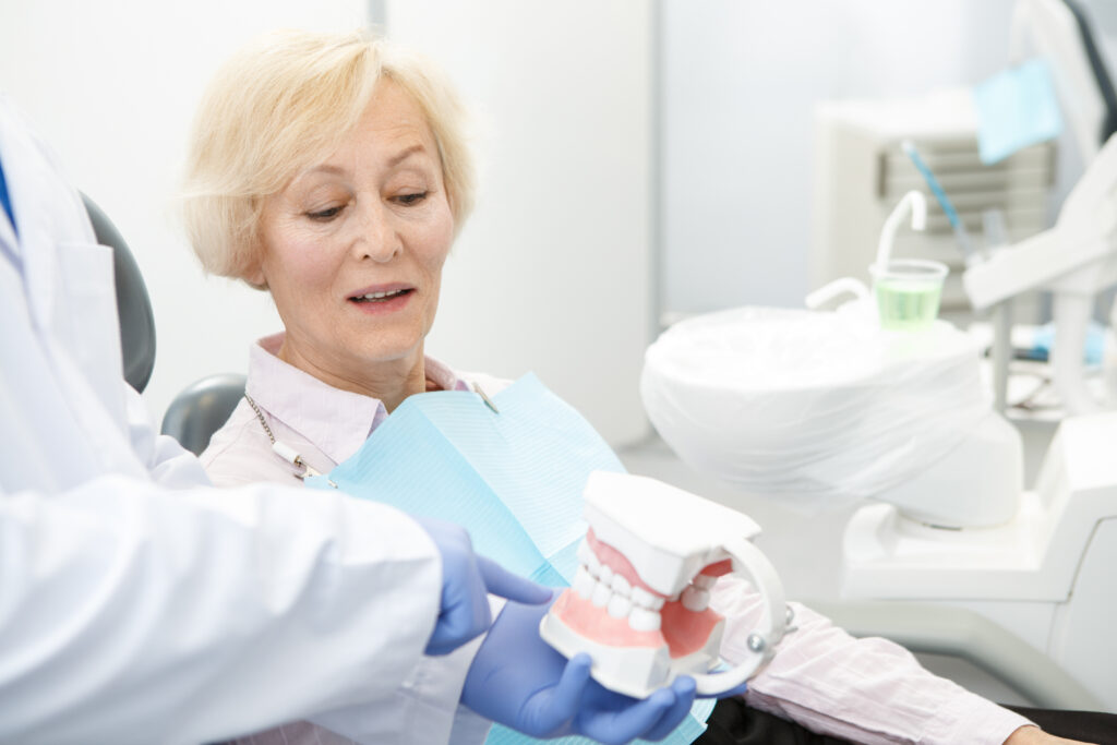 Oral Surgeon showing a patient teeth example