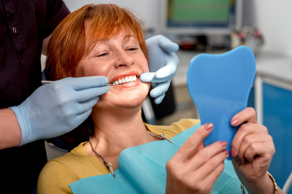 Patient looking at their new dental implants