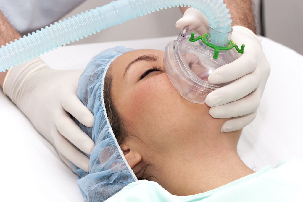 Woman receiving general anesthesia for an oral surgery