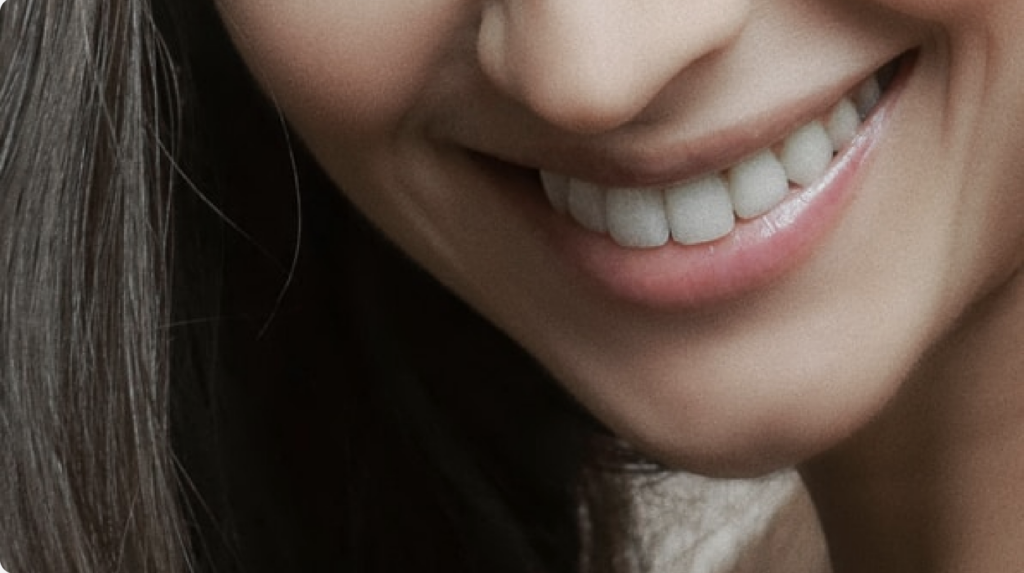 woman smiling after a successful oral surgery procedure like dental implants