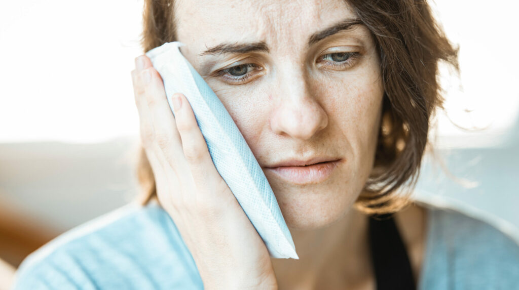 woman using an ice bag after an oral surgery