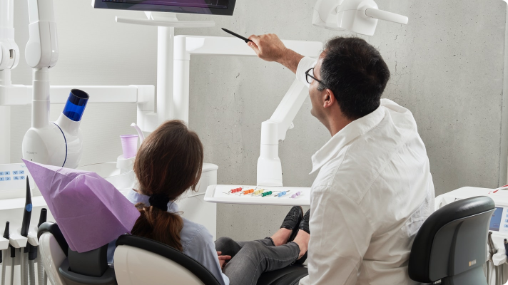 an oral surgeon showing a patient test results prior to their oral surgery procedure