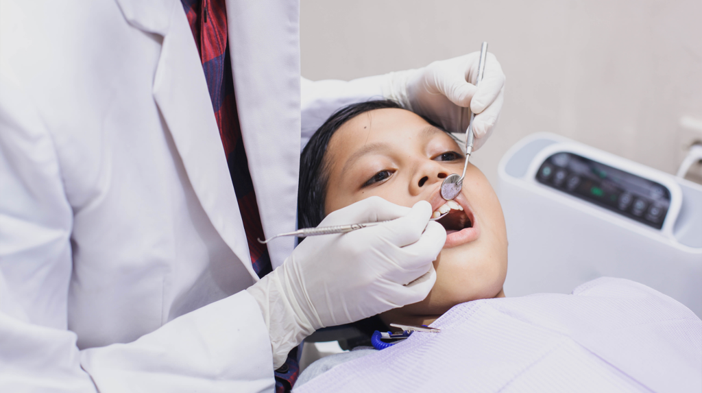 Child getting his teeth looked at by a oral surgeon